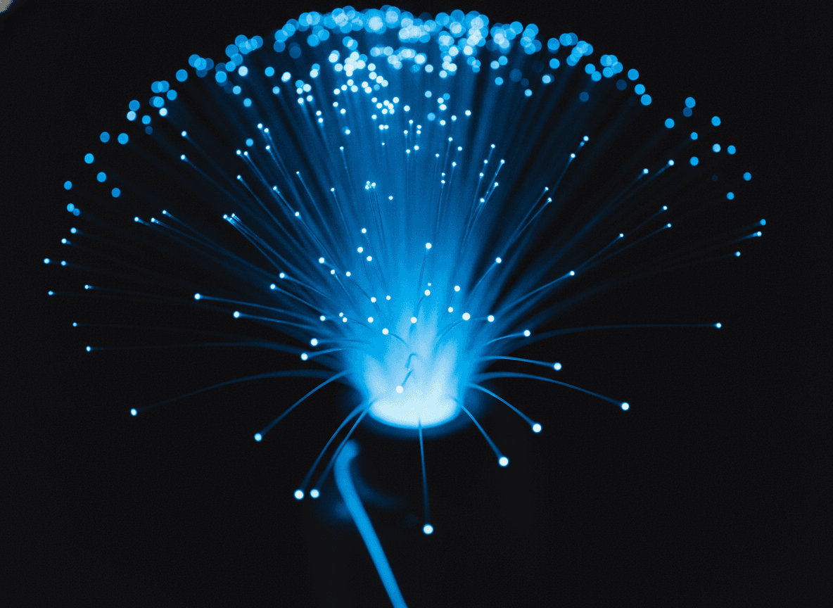 暗闇に青く光る光ファイバーの束 - Bundle of Fiber Optic Cables Glowing Blue in Darkness