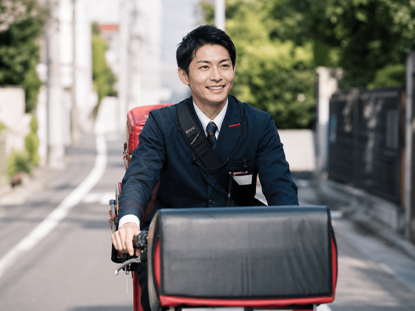 自転車で配達をする配達員 - Mail Carrier Delivering Packages by Bicycle