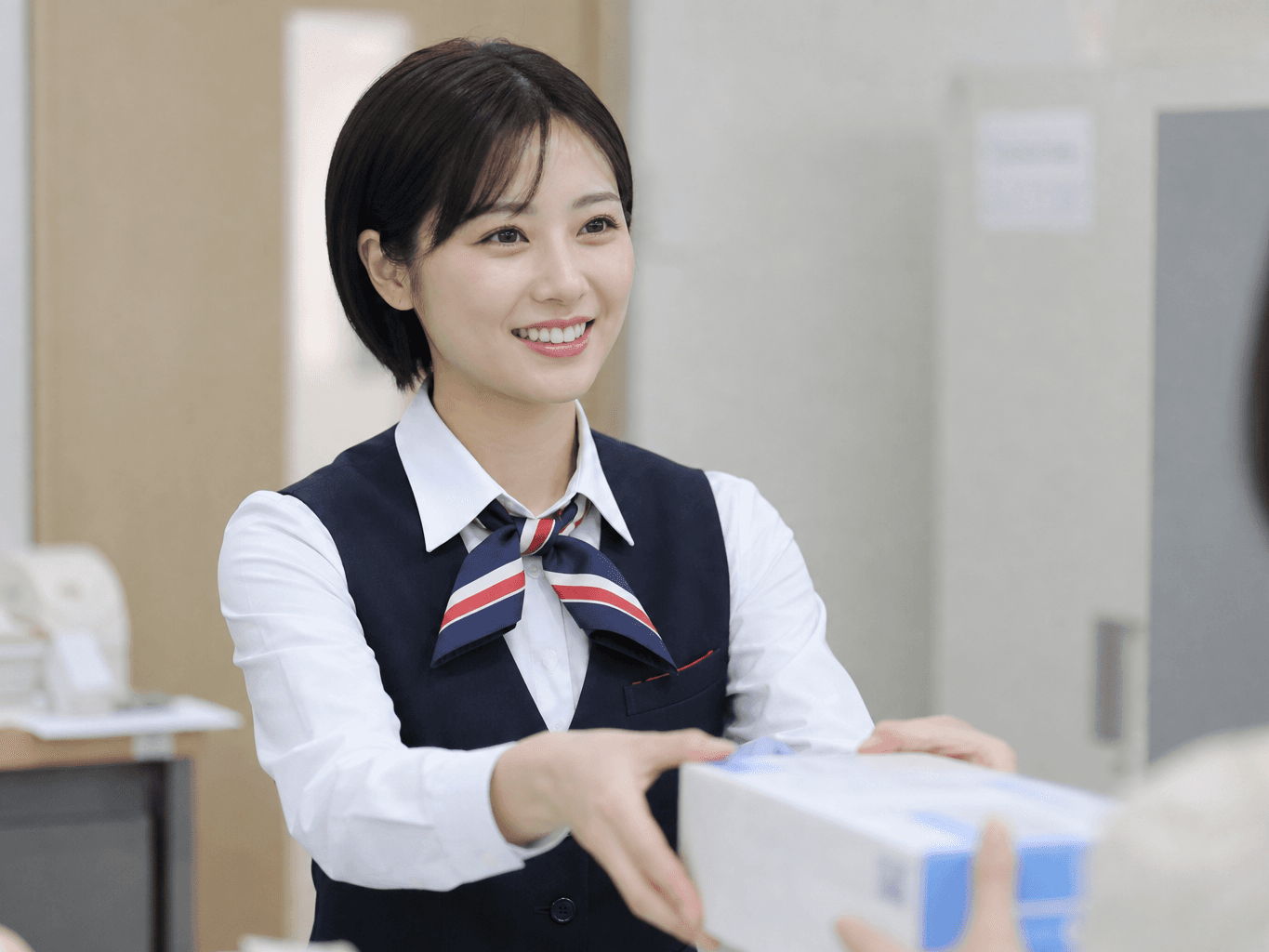 郵便窓口で荷物を受け付ける局員 - Post Office Clerk Accepting a Package